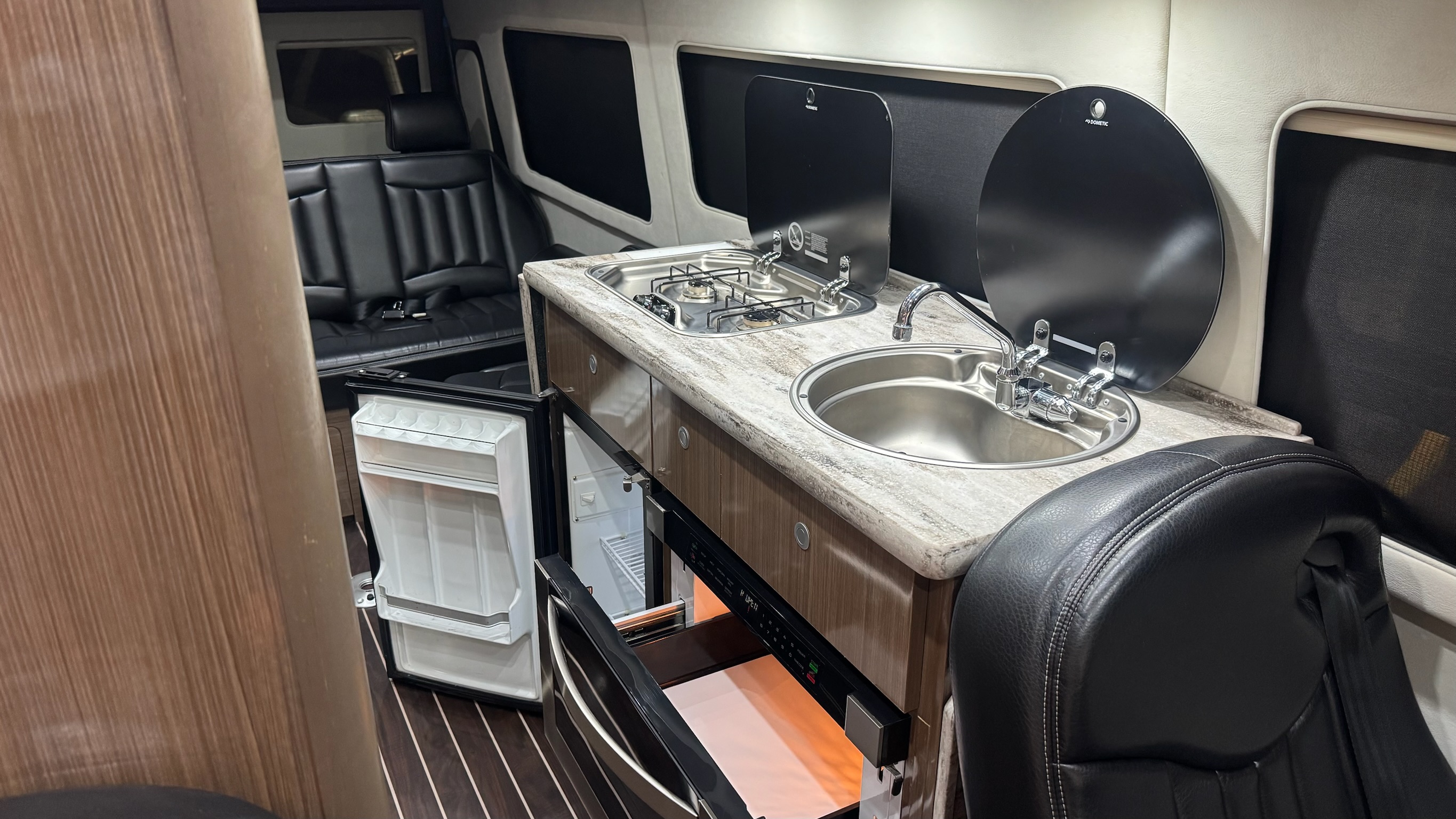 Kitchen — propane stove, granite countertop, sink, fridge